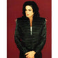Person wearing a black quilted jacket against a red 