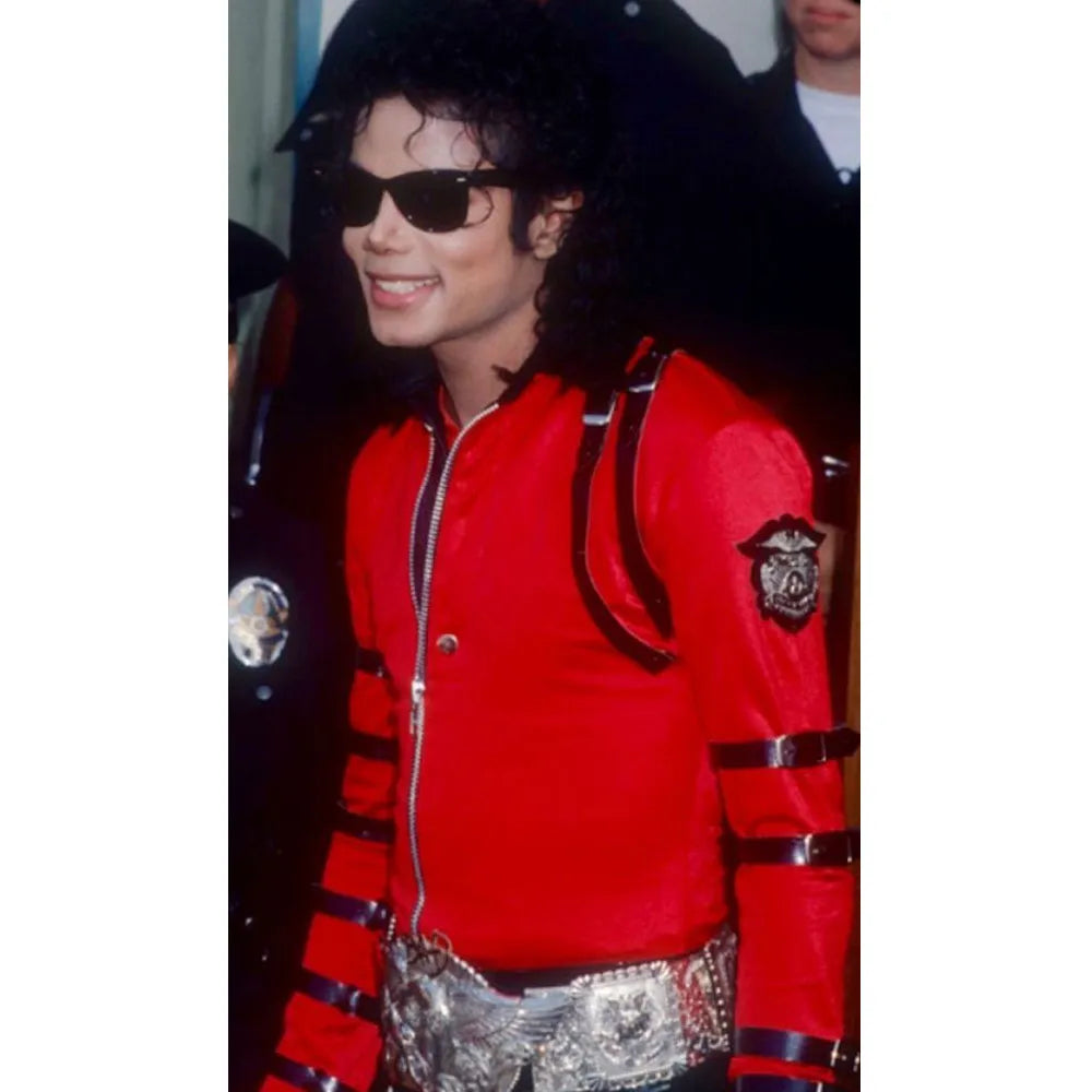 Person wearing a red jacket with black accents and sunglasses
