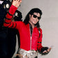 Person wearing a red jacket with black accents, holding a phone, with a plain background
