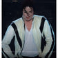 Person wearing a zebra-striped outfit with a white shirt underneath, against a dark background.