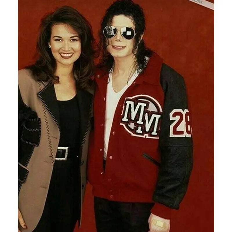 Two people posing together with a red background