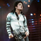 Person wearing a silver jacket with black accents on stage